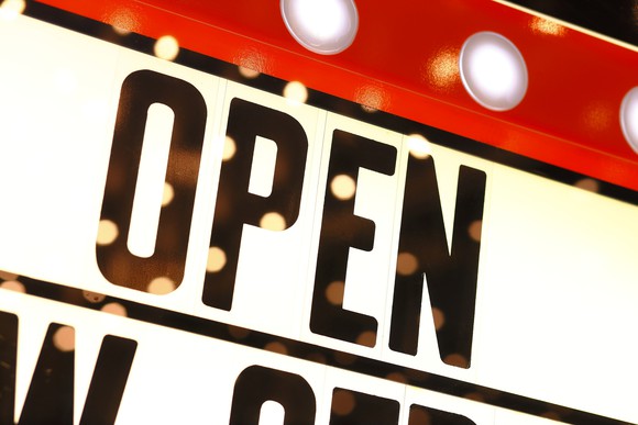 A movie marquee with the word "Open."