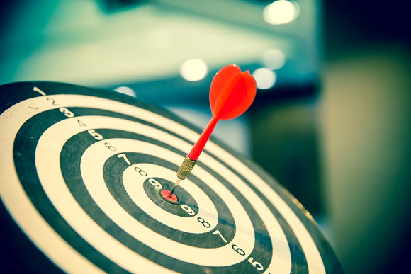 A dart hitting a bullseye.