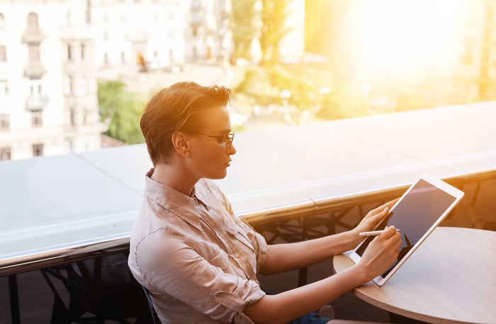 Businesswoman digitally signs a document on a tablet.