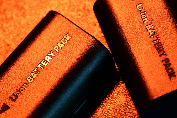 Two lithium-ion battery packs laying on a flat surface.