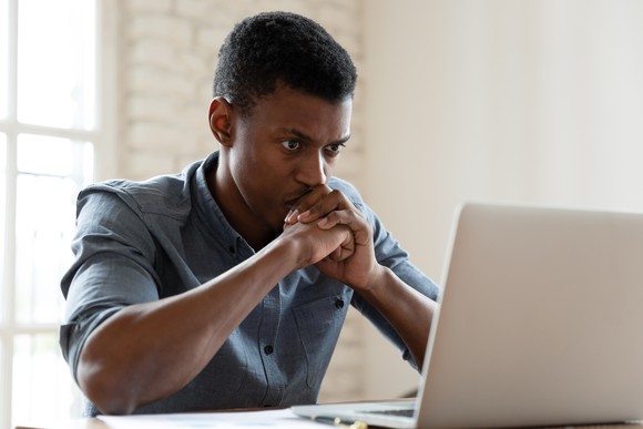 Man staring intently at laptop