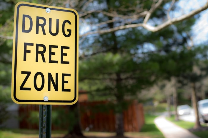 A drug free zone street sign in a residential neighborhood.