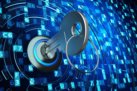 A key inside of a lock surrounded by dozens of alphanumeric codes.