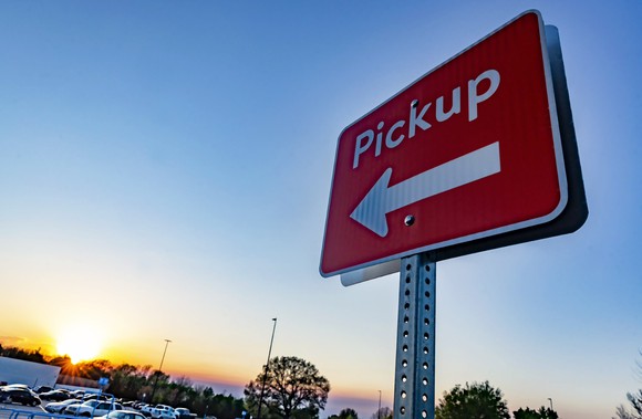 An outdoor pickup sign at a Walmart store.