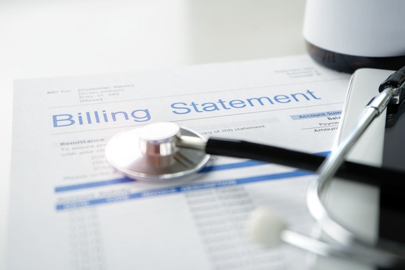 Stethoscope resting on billing statement.