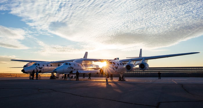 VSS Unity and VMS Eve on the ground with a sunrise in the background