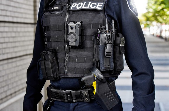 Police officer pictured from the shoulders down, with TASER and body camera