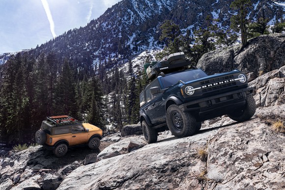 A pair of Ford Broncos on a mountainside