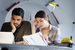 Worried Couple going over paperwork -- GettyImages-1019100668