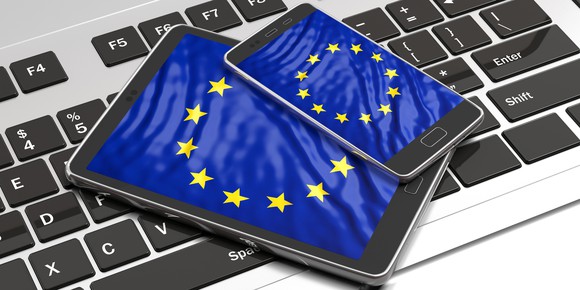 The European Union flag displayed on a smartphone and tablet.