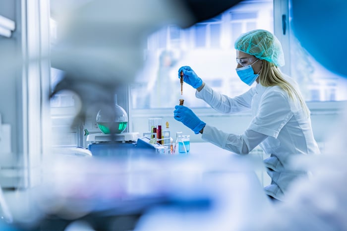 Scientist examining liquid in laboratory.