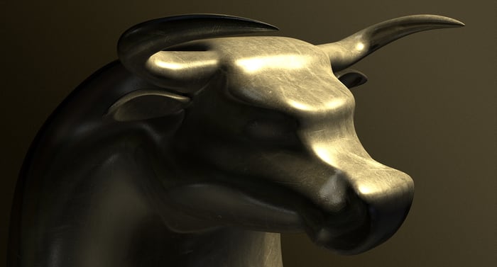 A bronze bull emerging from the shadows.