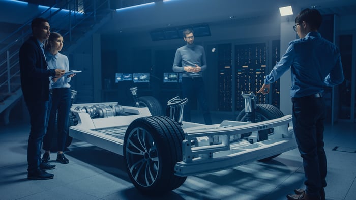 Engineers working on an electric vehicle.