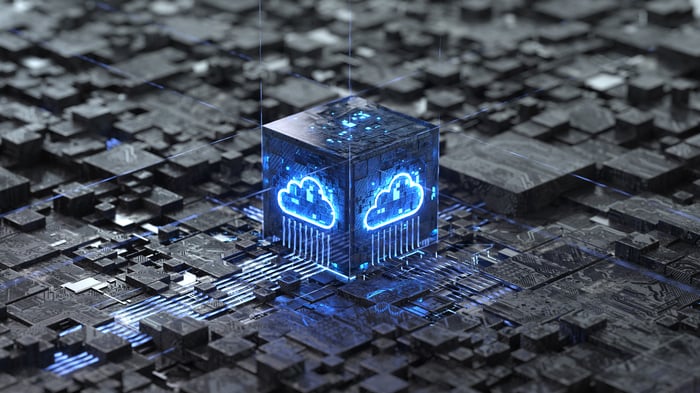 An illuminated blue cloud on a processor box that's surrounded by circuitry.