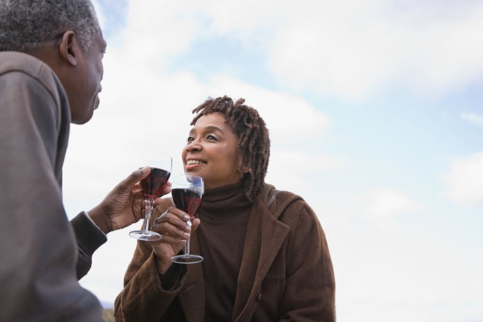 Older couple drinking wine together outside