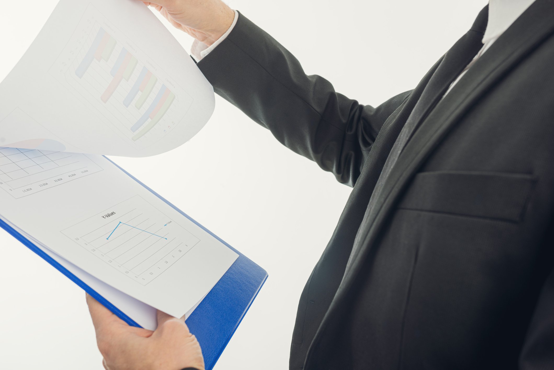 20_07_11 A man in a suit looking over paperwork on a clipboard _GettyImages-1200530833