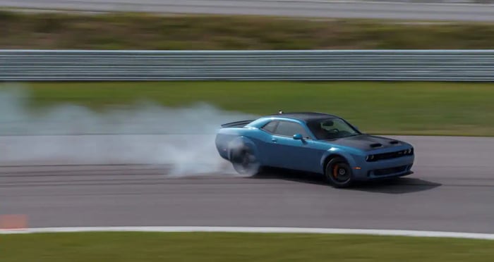 A Dodge Challenger SRT Hellcat Redeye being put through its paces on a track.