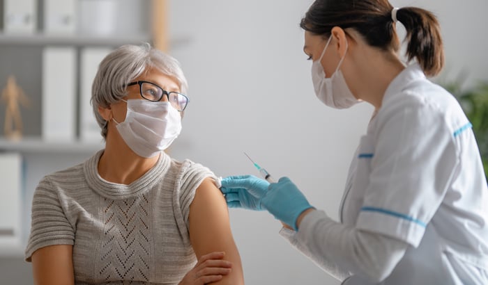 Nurse giving patient a vaccine. 