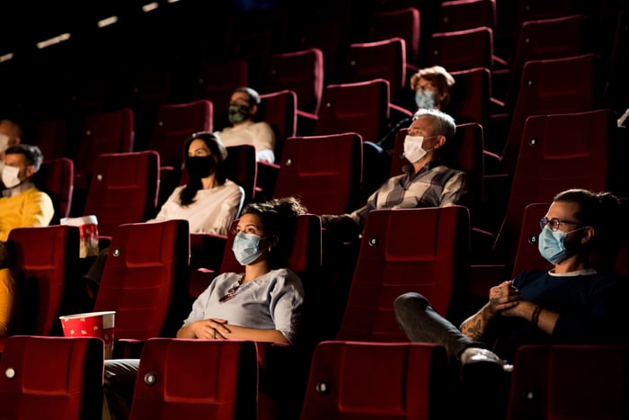 Group wearing masks in theatre