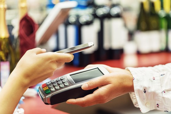 A customer uses a smartphone for contactless payment.