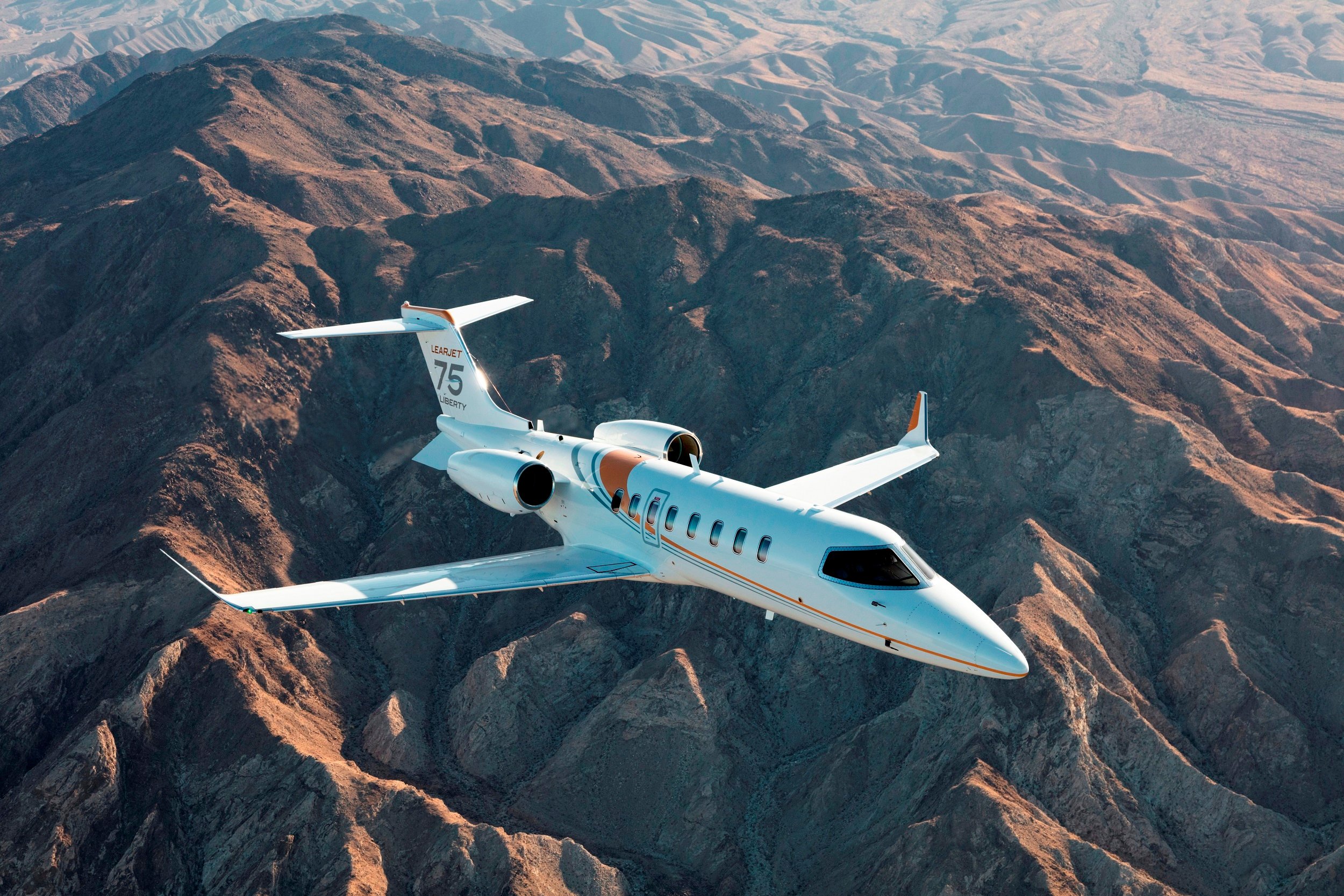 Learjet 75 Liberty flies above the mountains source Bombardier