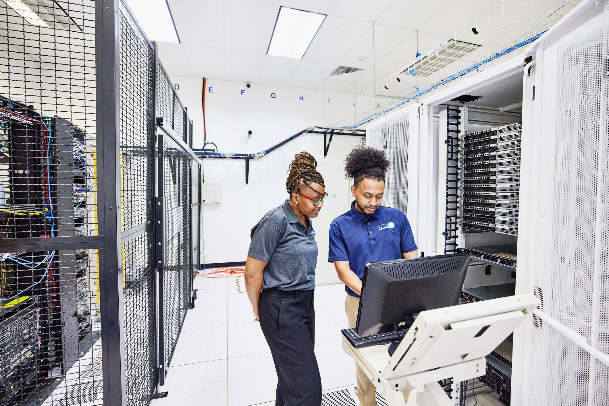 Information technology professionals configuring servers in a data center