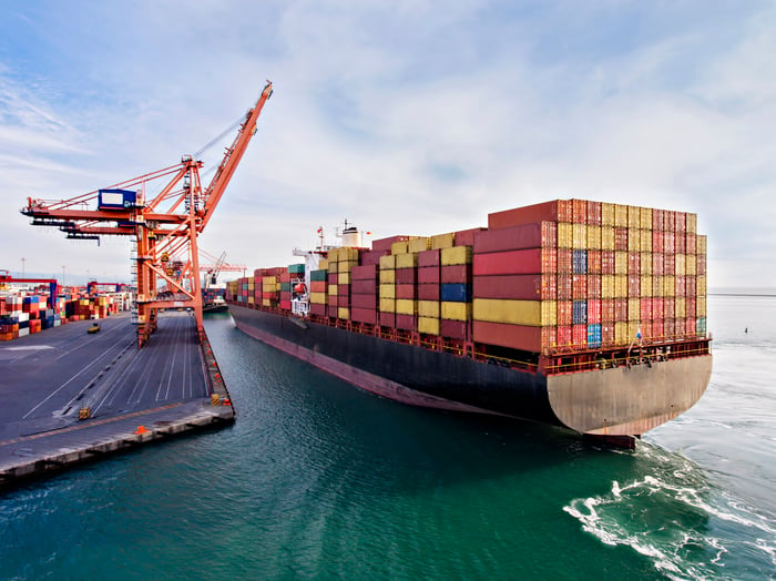 A cargo ship leaving port with a full load of containers.