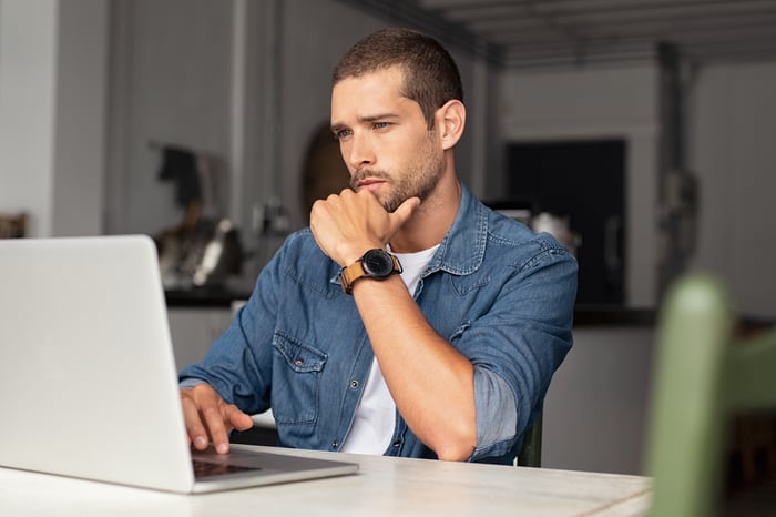 Man at laptop with serious expression