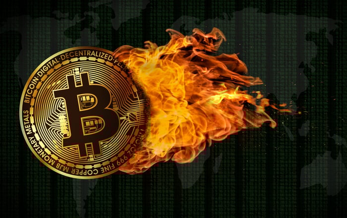 A physical gold Bitcoin that's leaving a fire trail.