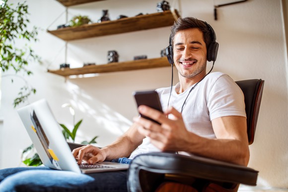 Man listening to music with a cellphone and headphones.