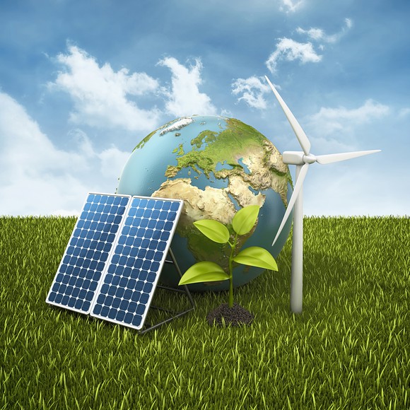 Globe, solar panel, wind turbine, and sapling