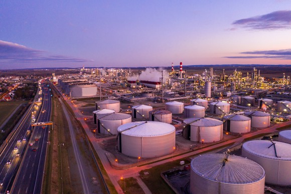 A bunch of tanks at an oil refinery.