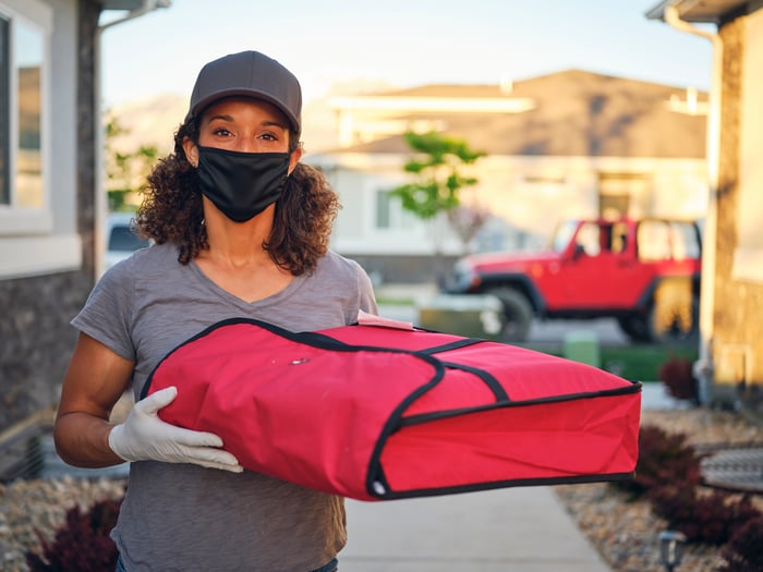A person with a food delivery bag.
