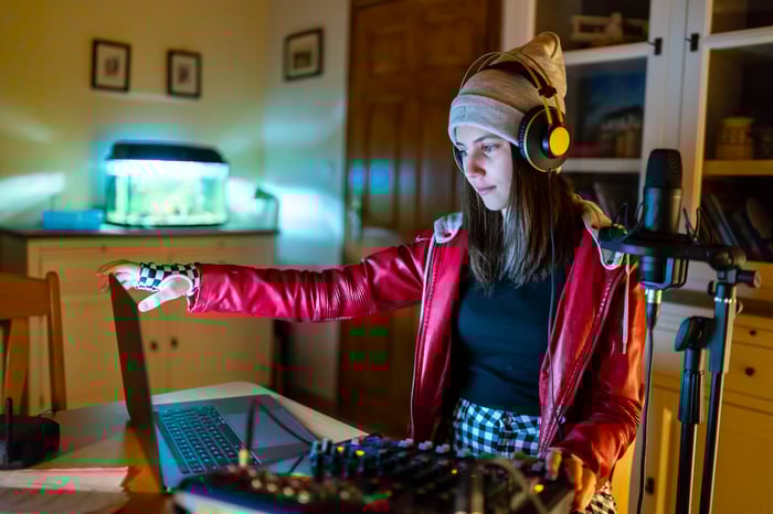 A young musician records a song at home.