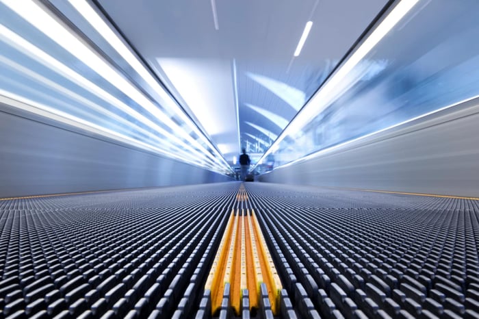 Moving walkway with focus on yellow center line.