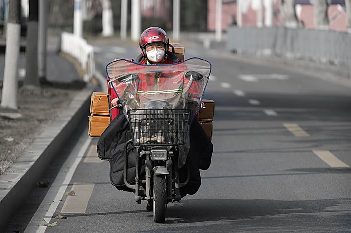 A JD.com delivery man making the rounds in the city of Wuhan.