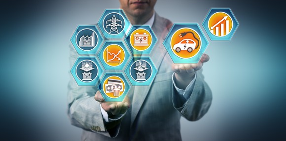 A person in a suit holding several renewable energy icons.