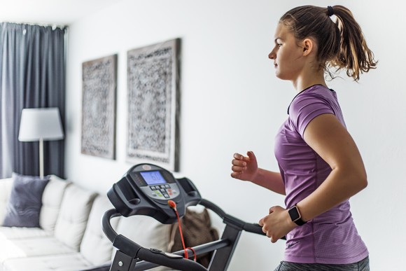 Lady running on treadmill at home