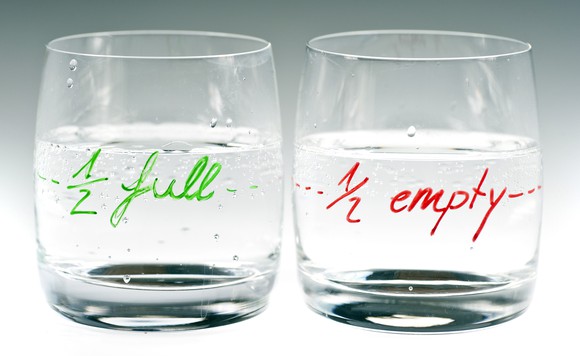 Two glasses, one labeled "one-half full" and the other "one-half empty."