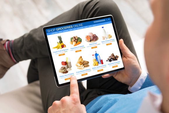 closeup on tablet with groceries on it as man shops for groceries.