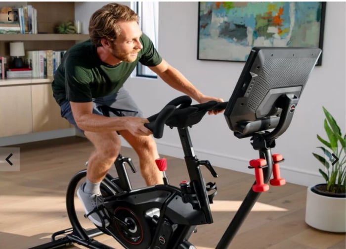 Youngish or middle-aged man riding a VeloCore exercise bike.