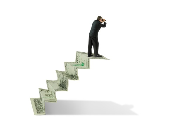 Investor on a staircase of money looking forward through binoculars