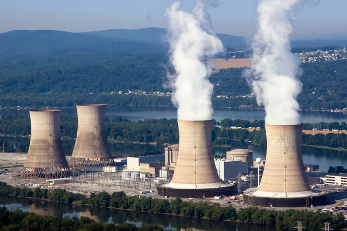 Steam rising from two operating nuclear power plants.