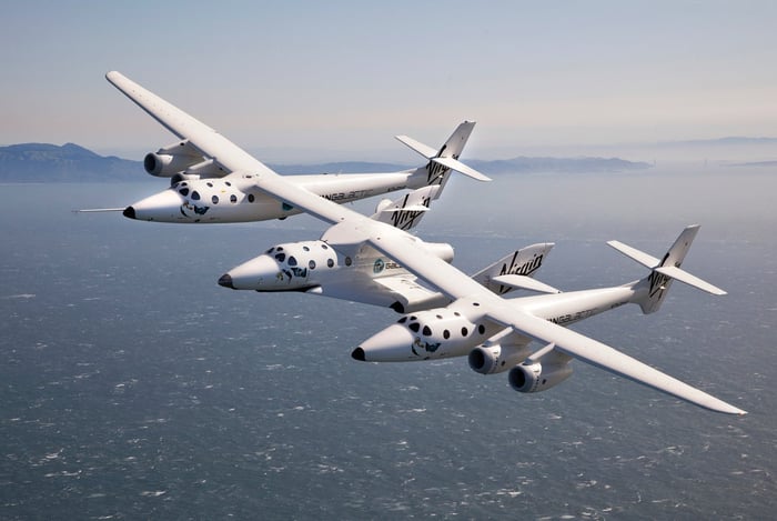 VMS Eve and VSS Unity flying over water.