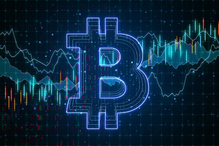 Bitcoin symbol on circuit board with graph