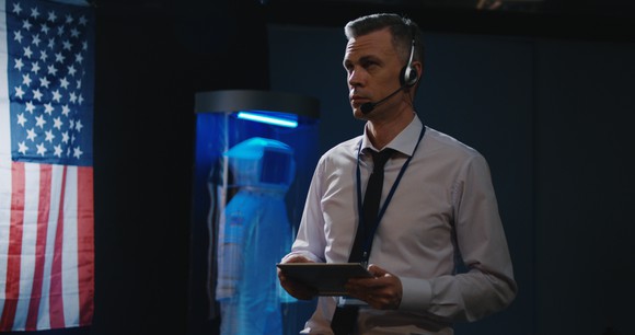 A mission control operator monitors a mission from a tablet.