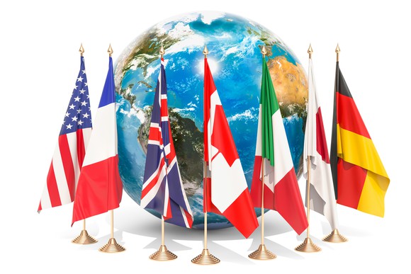The flags of the G7 countries in front of a globe.