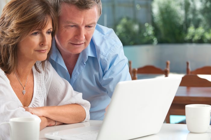 Two people looking at laptop