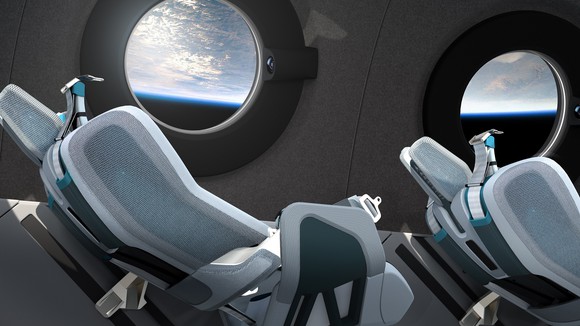Seats inside spacecraft looking at Earth from space.