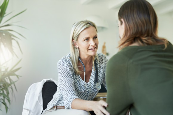 A doctor consults with a patient.